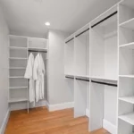 white walk in closet with black accents