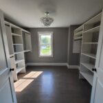 white walk in closet with black accents