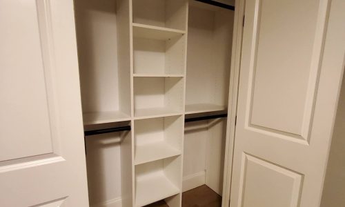 A reach-in closet with room to hang clothes and built-in shelving offers the perfect balance of simplicity and functionality.
