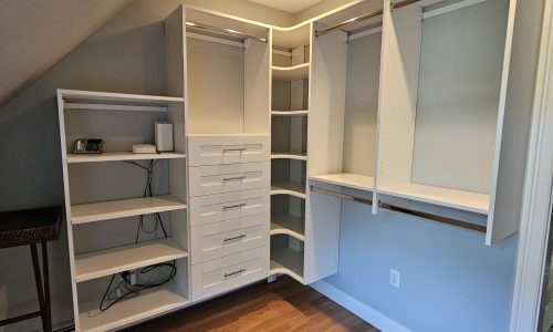 Compact Master Closet Design with White Melamine and Chrome Hardware